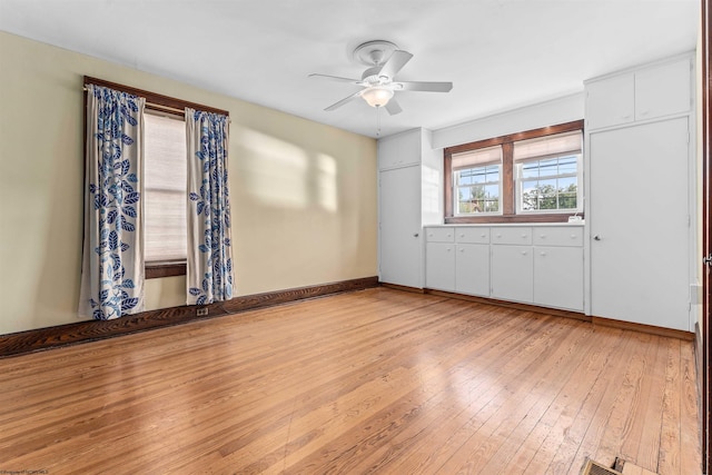 empty room featuring ceiling fan and light hardwood / wood-style floors