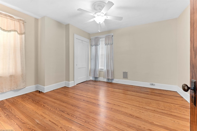 unfurnished room with light wood-type flooring and ceiling fan