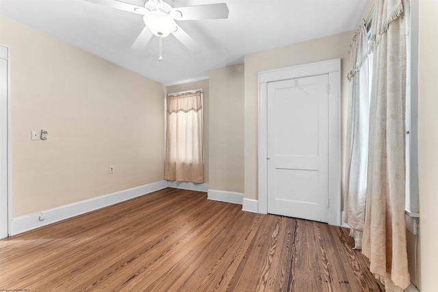 unfurnished bedroom with a closet, hardwood / wood-style floors, and ceiling fan