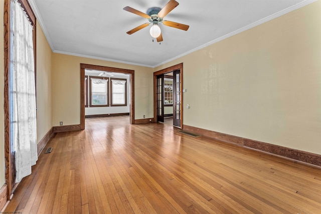 spare room featuring hardwood / wood-style flooring, ornamental molding, and ceiling fan