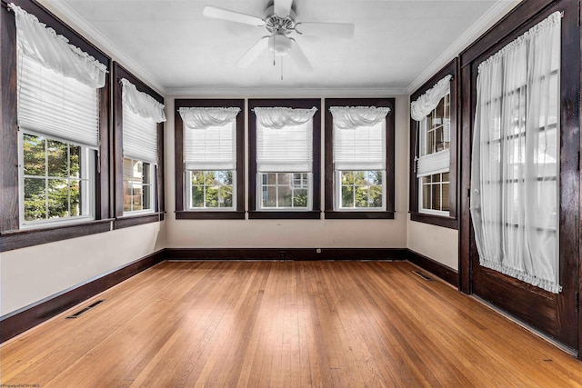 unfurnished room featuring ceiling fan, crown molding, and light hardwood / wood-style flooring