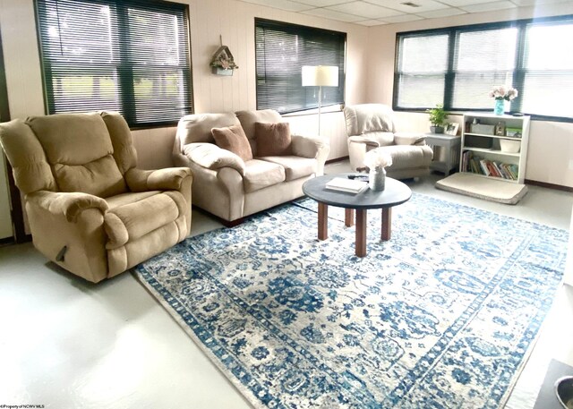 living room featuring a drop ceiling