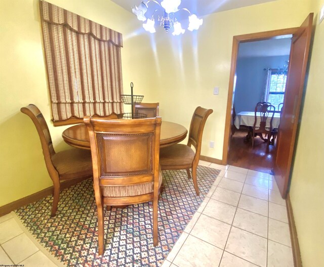 dining room featuring tile patterned floors and a chandelier