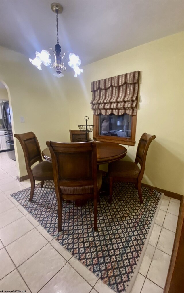 tiled dining area with a notable chandelier