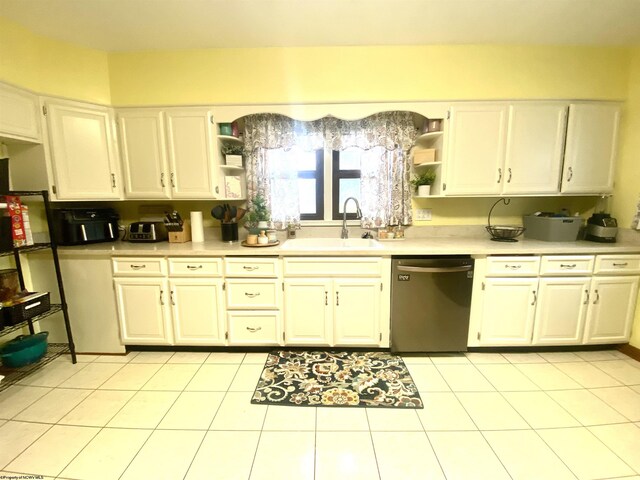 kitchen with light tile patterned flooring, sink, dishwasher, and white cabinets