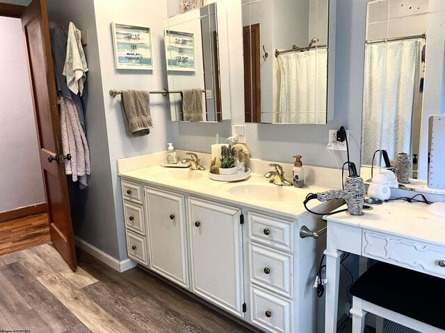 bathroom featuring double vanity and hardwood / wood-style floors