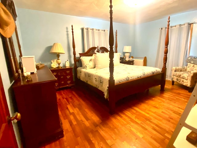 bedroom with hardwood / wood-style flooring