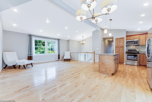 kitchen featuring a notable chandelier, stainless steel appliances, decorative backsplash, vaulted ceiling, and light hardwood / wood-style floors