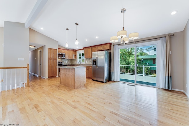 kitchen featuring light hardwood / wood-style flooring, stainless steel appliances, vaulted ceiling, pendant lighting, and decorative backsplash