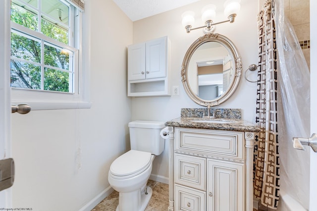 bathroom featuring tile patterned floors, vanity, a textured ceiling, and toilet