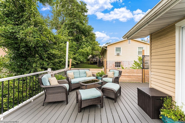 deck with an outdoor living space with a fire pit