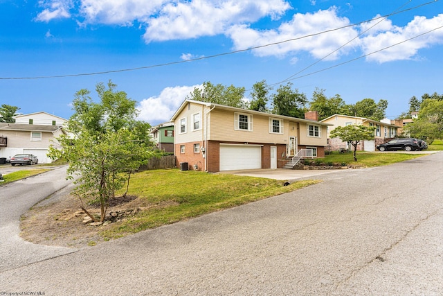 raised ranch with a garage and a front yard