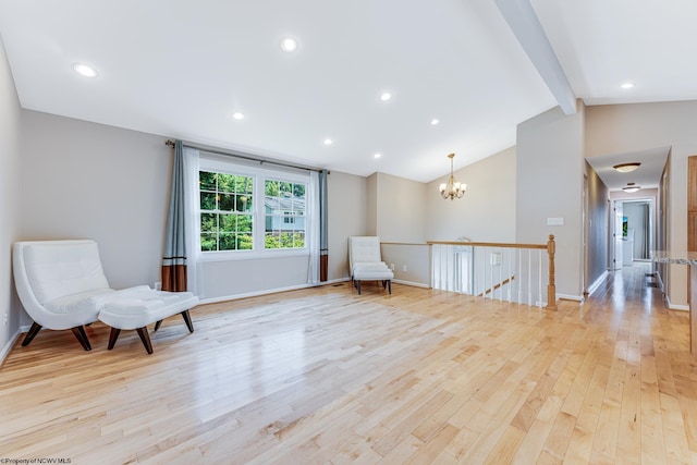 sitting room with light hardwood / wood-style floors, vaulted ceiling with beams, and a chandelier