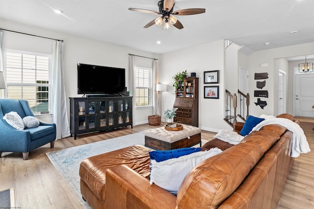 living room featuring ceiling fan and light hardwood / wood-style flooring