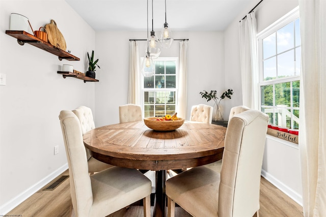 dining space with light wood-type flooring