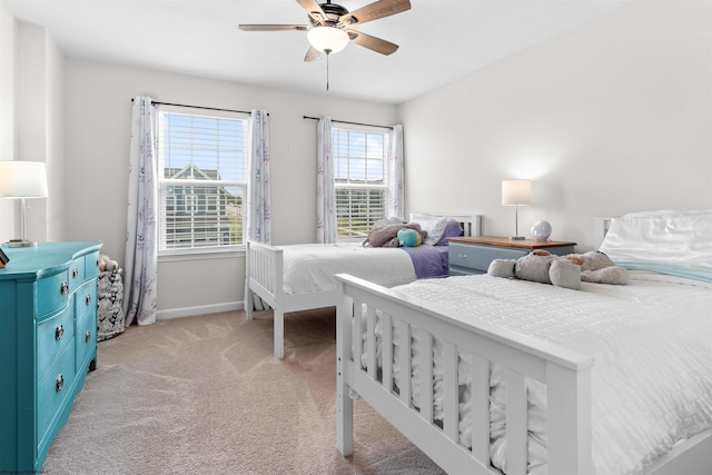 bedroom with ceiling fan and light colored carpet