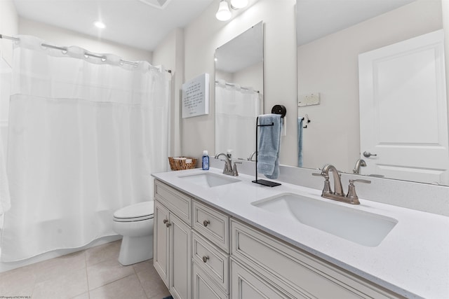 full bathroom featuring double vanity, toilet, shower / bath combo with shower curtain, and tile patterned flooring