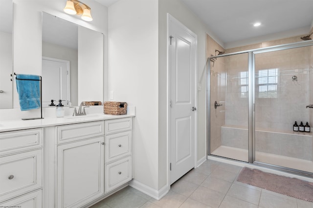 bathroom featuring vanity, a shower with door, and tile patterned flooring