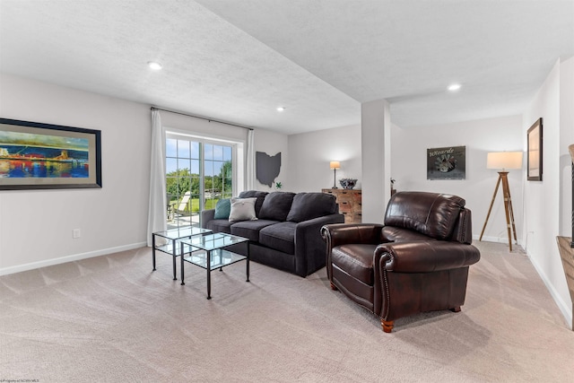 living room featuring a textured ceiling and light colored carpet