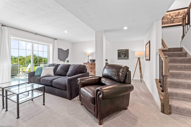 carpeted living room featuring a textured ceiling