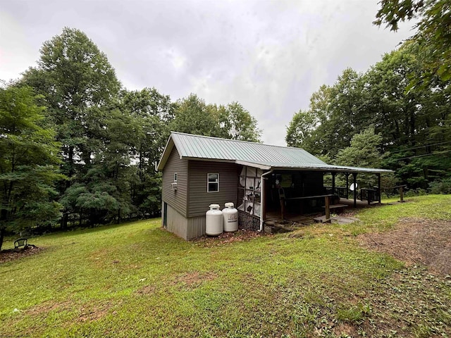 view of outbuilding featuring a yard