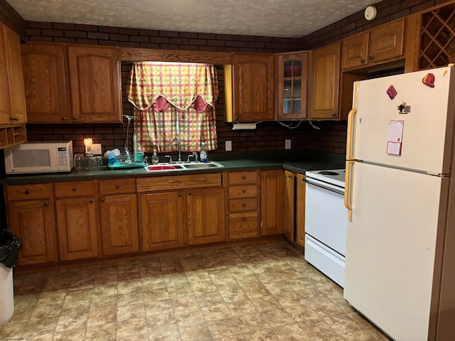 kitchen featuring white appliances, sink, and light tile patterned floors