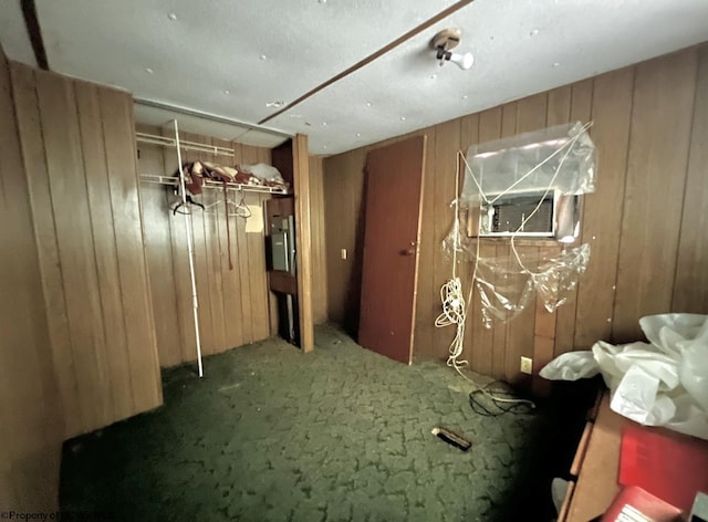 miscellaneous room with carpet flooring and wood walls