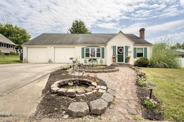 single story home featuring a garage, concrete driveway, a front lawn, and a chimney