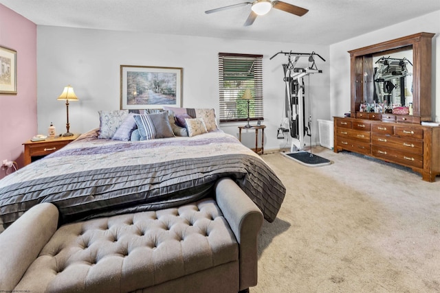 carpeted bedroom featuring ceiling fan, a textured ceiling, and baseboards