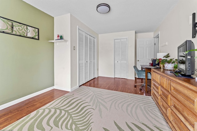 home office with wood finished floors and baseboards