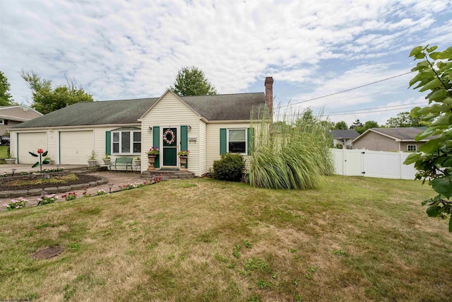 ranch-style home featuring a garage, concrete driveway, a chimney, fence, and a front yard