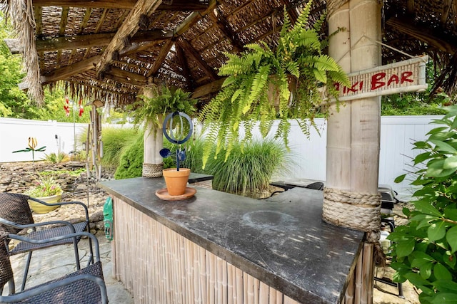 view of patio / terrace featuring fence and outdoor dry bar