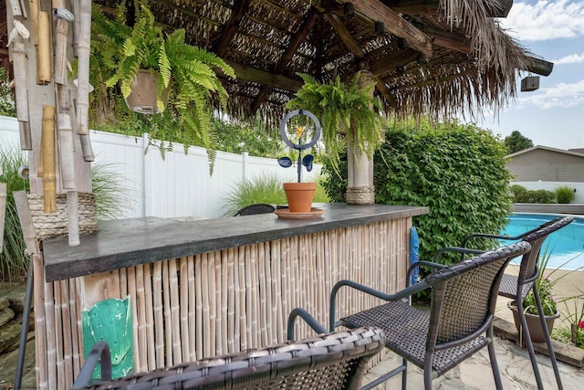 view of patio / terrace with fence and outdoor dry bar