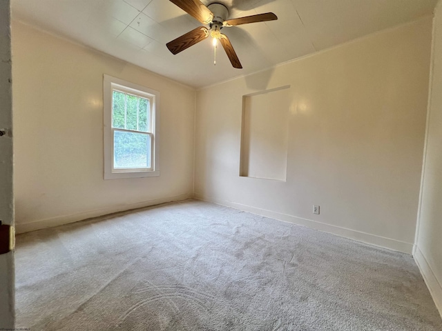 empty room with a ceiling fan, baseboards, and carpet flooring