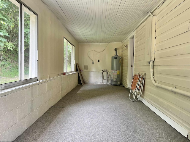 unfurnished sunroom with wood ceiling and water heater