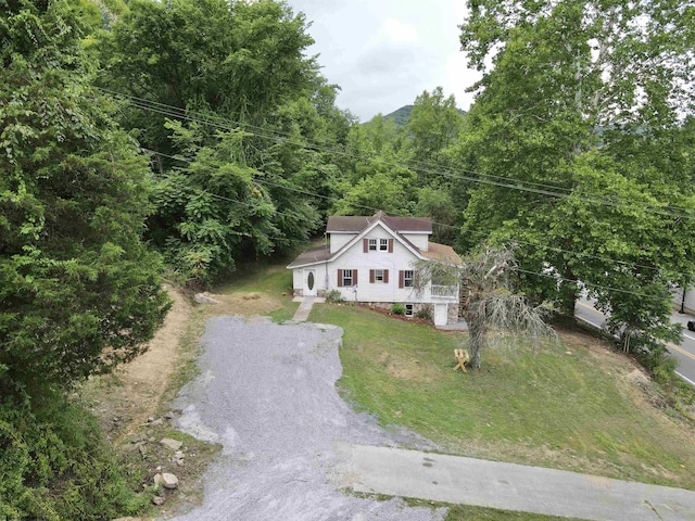 drone / aerial view featuring a wooded view