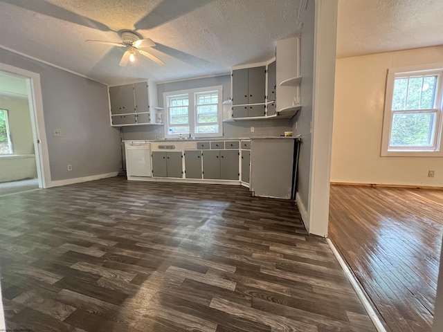 kitchen with a textured ceiling, dark wood finished floors, open shelves, and dishwasher