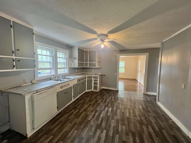 kitchen with dishwasher, dark wood-style flooring, light countertops, open shelves, and a sink