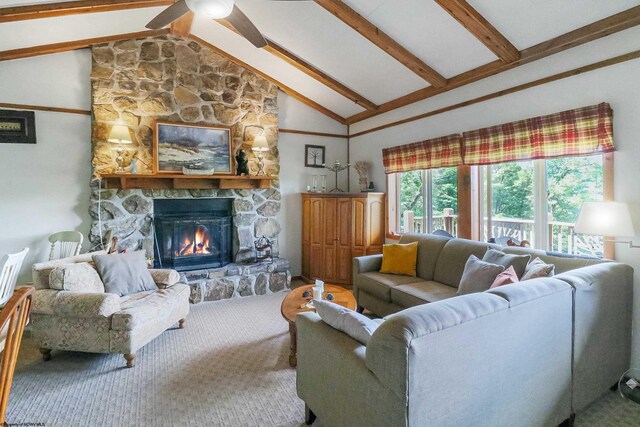 carpeted living room featuring beam ceiling, ceiling fan, high vaulted ceiling, and a stone fireplace