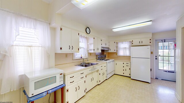 kitchen featuring white cabinets, sink, white appliances, and light tile patterned floors