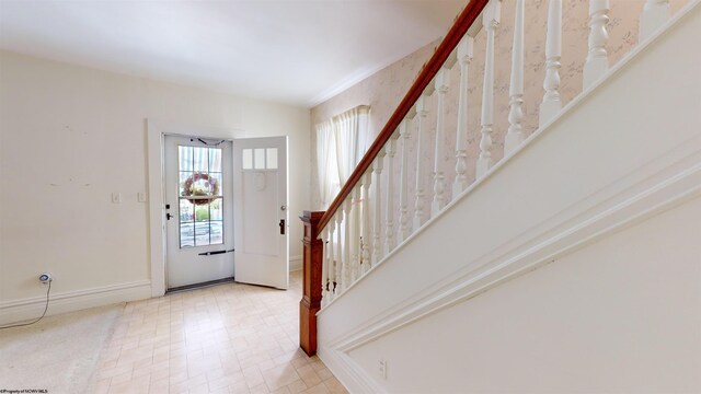 view of carpeted foyer entrance