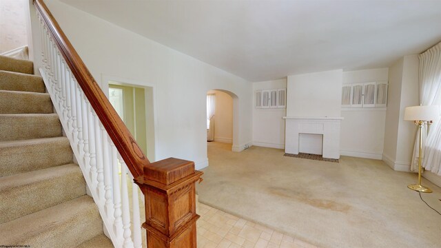 unfurnished living room featuring light carpet