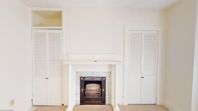 unfurnished living room featuring light colored carpet