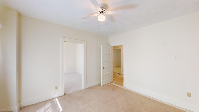 unfurnished bedroom with ceiling fan and light colored carpet