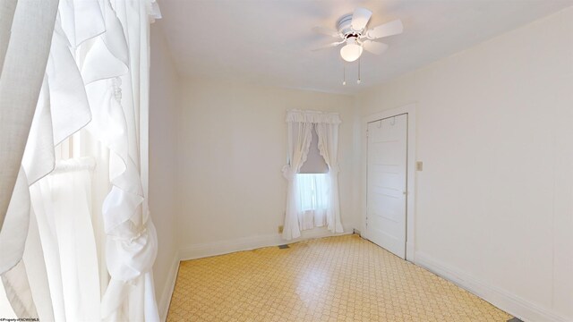 interior space with ceiling fan and light tile patterned floors