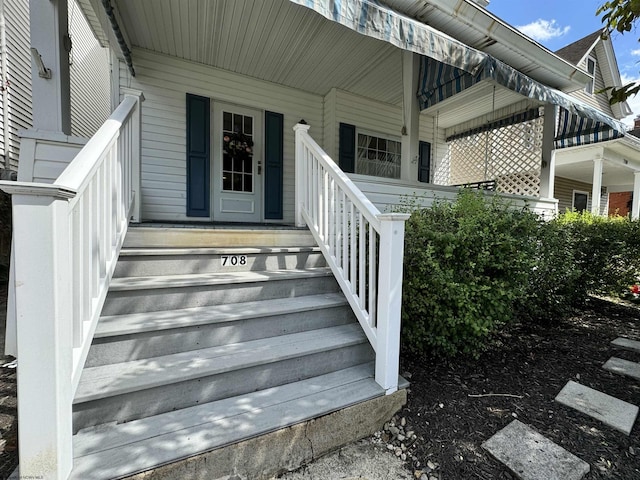 doorway to property featuring covered porch