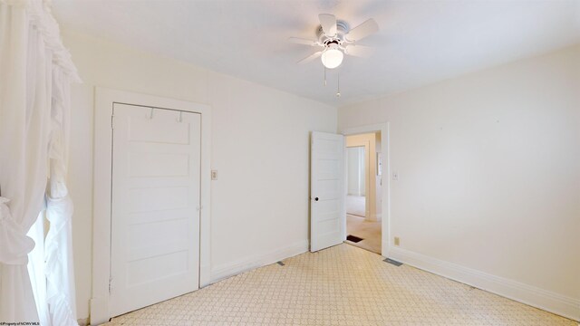 unfurnished bedroom with a closet and ceiling fan