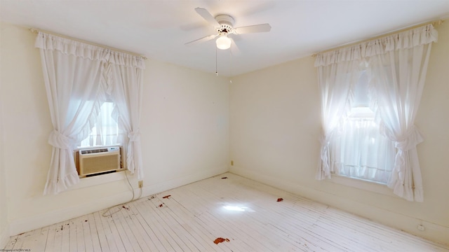 unfurnished room featuring ceiling fan, light hardwood / wood-style floors, and cooling unit