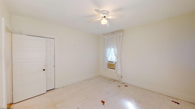 unfurnished room with cooling unit, ceiling fan, and light hardwood / wood-style floors