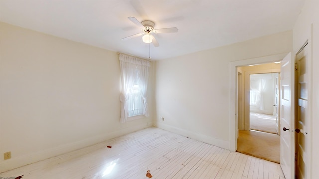 unfurnished room featuring ceiling fan and light colored carpet